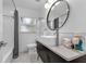 Well-lit bathroom with vessel sink, hexagon tile floors, and a shower-tub combo at 2201 Delaney. Ave, Orlando, FL 32806