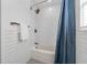 Clean bathroom featuring a shower-tub with white subway tile and gold hardware at 2201 Delaney. Ave, Orlando, FL 32806