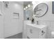 Beautiful bathroom featuring modern vanity, white geometric tiling, glass-enclosed shower, and contemporary fixtures at 2201 Delaney. Ave, Orlando, FL 32806