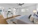 Relaxing bedroom boasts hardwood floors, modern ceiling fan, barn door leading to bathroom, and bright windows at 2201 Delaney. Ave, Orlando, FL 32806