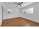 Light, bright bedroom with hardwood floors and two windows at 2201 Delaney. Ave, Orlando, FL 32806