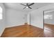 Bright bedroom with hardwood floors, ceiling fan and mirrored closet at 2201 Delaney. Ave, Orlando, FL 32806