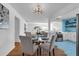 Bright dining area showcasing stylish table set, modern lighting, and access to the updated kitchen at 2201 Delaney. Ave, Orlando, FL 32806