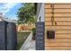 Side yard featuring modern horizontal wood accents and privacy fence at 2201 Delaney. Ave, Orlando, FL 32806
