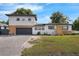 Modern two-story house featuring a gray exterior, a garage and a well-kept lawn at 2201 Delaney. Ave, Orlando, FL 32806