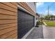 Attached garage with paved driveway and landscaping at 2201 Delaney. Ave, Orlando, FL 32806