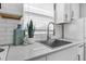 Close-up of a well-lit kitchen sink with white subway tile and sleek countertops at 2201 Delaney. Ave, Orlando, FL 32806