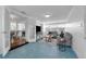 Bright living room with blue geometric tile floors, modern furnishings, and plenty of natural light at 2201 Delaney. Ave, Orlando, FL 32806