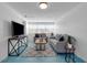Inviting living room with neutral tones, geometric tile flooring, comfortable seating, and a modern entertainment center at 2201 Delaney. Ave, Orlando, FL 32806
