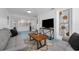 Comfortable living room featuring stylish decor, white brick walls, geometric tile flooring, and lots of natural light at 2201 Delaney. Ave, Orlando, FL 32806