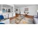 Bright open-concept space with hardwood floors connecting living area, kitchen, and dining at 2201 Delaney. Ave, Orlando, FL 32806