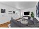 Bright living room features hardwood floors, modern decor, and neutral color palette at 2201 Delaney. Ave, Orlando, FL 32806