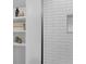 Close up on the white subway tile shower with built in niche and shelves at 2201 Delaney. Ave, Orlando, FL 32806