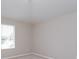 Light bedroom features neutral walls and a large window overlooking scenic views at 6893 Hidden Glade Pl, Sanford, FL 32771