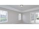 Bright bedroom features natural light from two windows and access to the outside via French doors at 6893 Hidden Glade Pl, Sanford, FL 32771