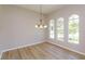 Dining room featuring hardwood floors, crown moulding and three large windows at 6893 Hidden Glade Pl, Sanford, FL 32771