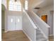 Grand foyer boasts soaring ceilings, staircase, and elegant flooring creating an impressive entrance at 6893 Hidden Glade Pl, Sanford, FL 32771