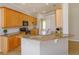 Kitchen featuring granite counters, stainless steel appliances, and ample wood cabinetry at 6893 Hidden Glade Pl, Sanford, FL 32771