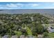Panoramic aerial view highlighting a residential area with lush greenery, homes, and a stunning lake backdrop at 1669 Markel Dr, Winter Garden, FL 34787