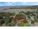 Aerial view of a neighborhood showcasing the home lot outlined in red, surrounded by lush trees and a scenic lake at 1669 Markel Dr, Winter Garden, FL 34787