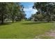 Expansive lot offering ample space with lush grass and mature trees for shade at 1669 Markel Dr, Winter Garden, FL 34787