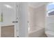 Clean bathroom with a bathtub, tile flooring, and access to the bedroom at 3211 Eagle Watch Dr, Kissimmee, FL 34746