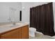 Bathroom featuring a vanity, toilet and shower with dark curtain at 3211 Eagle Watch Dr, Kissimmee, FL 34746