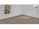 Empty bedroom with plush carpet and large windows offering ample natural light and a view of the outdoors at 3211 Eagle Watch Dr, Kissimmee, FL 34746