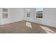 Sunny bedroom with neutral carpet, offering great natural light through two large windows at 3211 Eagle Watch Dr, Kissimmee, FL 34746