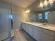 Bathroom with double sink vanity, quartz countertop, and a glass shower at 9332 Bolshoi Aly, Winter Garden, FL 34787