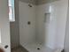 Modern bathroom with a tiled shower, a shower niche, and brushed silver fixtures at 9332 Bolshoi Aly, Winter Garden, FL 34787