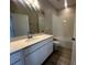 Neutral bathroom features a white vanity with ample counter space, decorative floors, and a shower-tub combo at 9332 Bolshoi Aly, Winter Garden, FL 34787