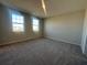 Empty bedroom with carpet floors and two windows bringing in natural light at 9332 Bolshoi Aly, Winter Garden, FL 34787