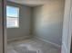 An empty bedroom with an exterior view and an electrical outlet at 9332 Bolshoi Aly, Winter Garden, FL 34787