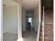 Entryway of a home showing stairs, tile floors, and views into the kitchen at 9332 Bolshoi Aly, Winter Garden, FL 34787