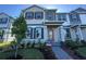 Beautiful two-story home featuring gray, beige, and white exterior with a brick walkway and tasteful landscaping at 9332 Bolshoi Aly, Winter Garden, FL 34787