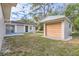 A view of the backyard showing the home and detached garage at 1009 Perkins St, Leesburg, FL 34748