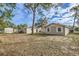 A view of the backyard showing home and storage buildings at 1009 Perkins St, Leesburg, FL 34748