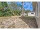 A view of the backyard with trees and ample space at 1009 Perkins St, Leesburg, FL 34748