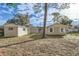 A view of the backyard showing home and storage buildings at 1009 Perkins St, Leesburg, FL 34748