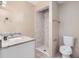 This bathroom has a white vanity, toilet and updated tile shower at 1009 Perkins St, Leesburg, FL 34748