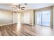 Bedroom featuring hardwood floors, ceiling fan, and sliding doors to the outside at 1009 Perkins St, Leesburg, FL 34748