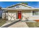 Inviting front entrance featuring a vibrant red door, modern lighting, and updated exterior at 1009 Perkins St, Leesburg, FL 34748