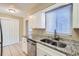 Bright kitchen with granite countertops, stainless steel appliances, and white cabinetry at 1009 Perkins St, Leesburg, FL 34748