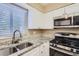 Updated kitchen featuring stainless steel appliances, granite countertops, and modern cabinetry at 1009 Perkins St, Leesburg, FL 34748