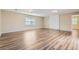Spacious living room featuring hardwood flooring, neutral paint, and ample natural light at 1009 Perkins St, Leesburg, FL 34748