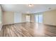 Large living room with hardwood floors, neutral walls, and access to the patio at 1009 Perkins St, Leesburg, FL 34748