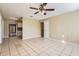 Open-concept living area featuring tiled floors and seamless transitions to the kitchen and hallway at 1009 Perkins St, Leesburg, FL 34748