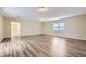 Open-concept living room with hardwood flooring, bright lighting, and a neutral color palette at 1009 Perkins St, Leesburg, FL 34748