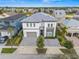 Stunning two-story home showcasing a paved driveway and a neutral color scheme at 1529 Corolla Ct, Reunion, FL 34747